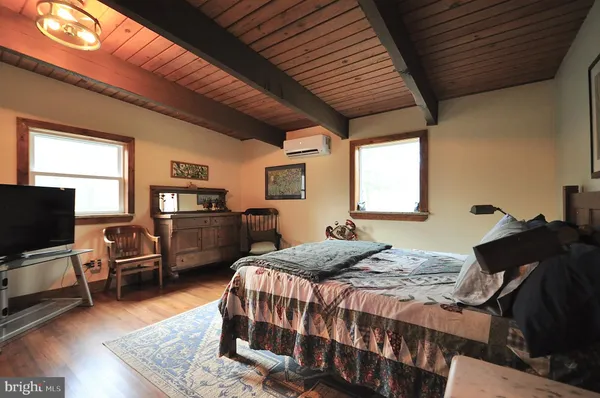 a bedroom with a bed and a television
