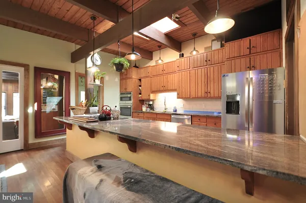a kitchen with counter top space a sink and appliances