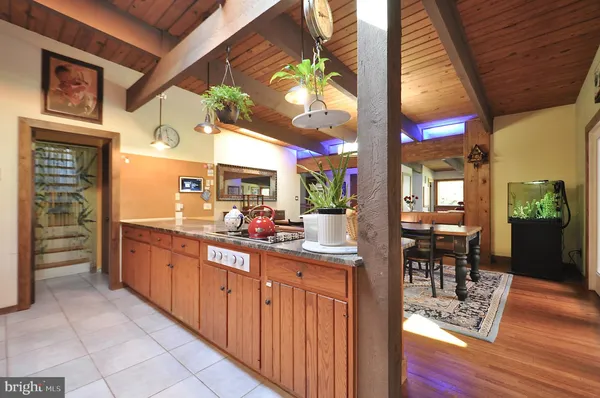 a kitchen with stainless steel appliances granite countertop a stove a sink and a dining table
