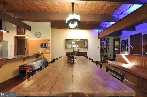 a living room with furniture a large window and wooden floor