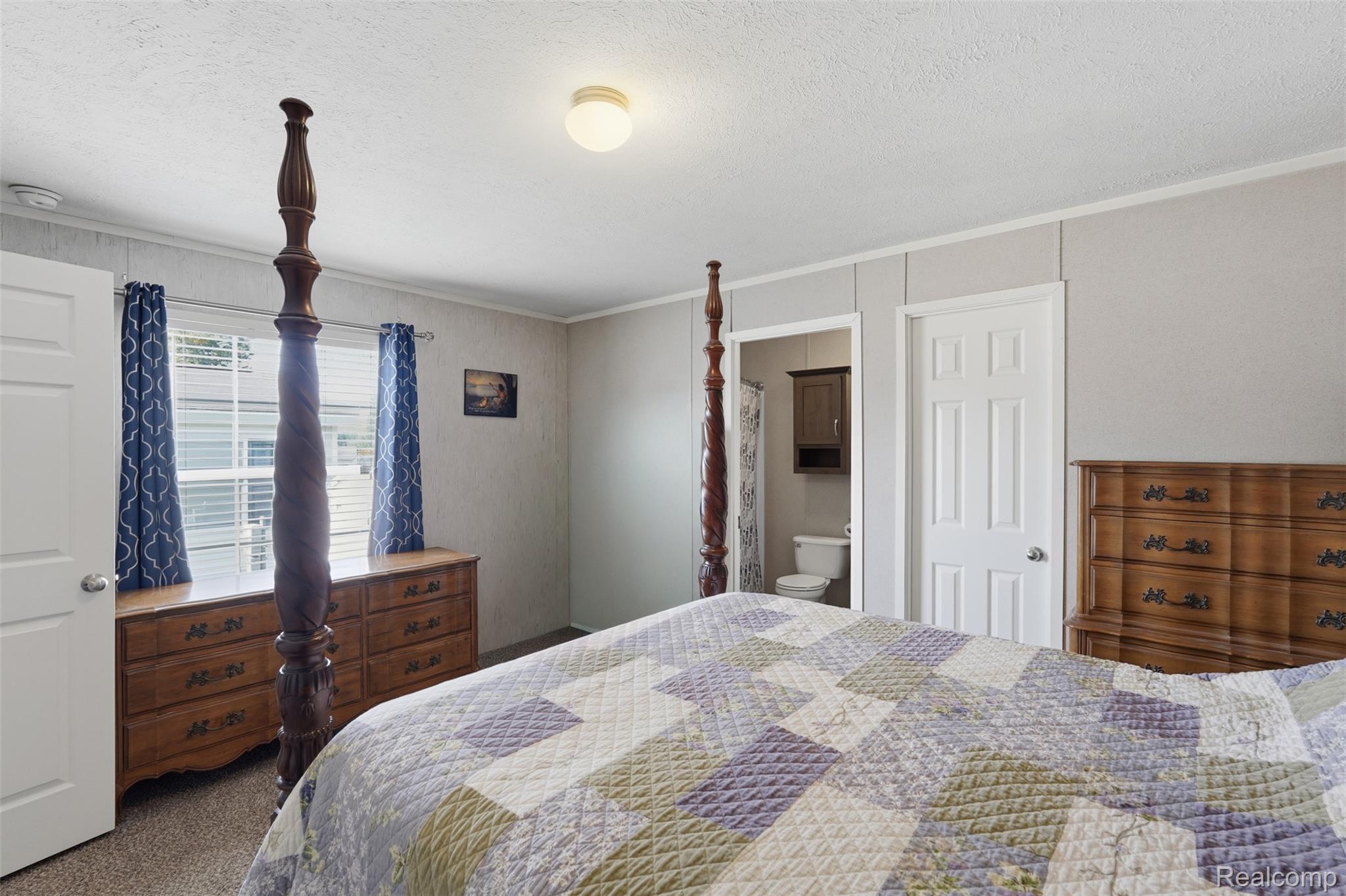 92 Normandy Drive Howell, MI 48843 - Photo 12 of 24 Bedroom with textured walls and carpet flooring