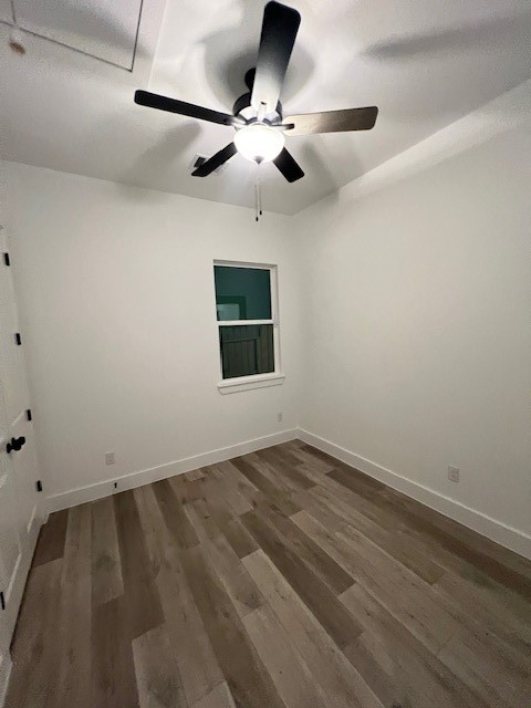 8508 Wileyvale Road, Unit B Houston, TX 77016 - Photo 12 of 16 an empty room with wooden floor ceiling fan and windows
