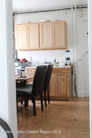 a kitchen with a sink cabinets and wooden floor