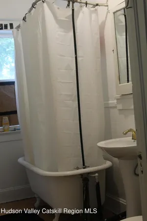 a bathroom with a sink a toilet and a shower