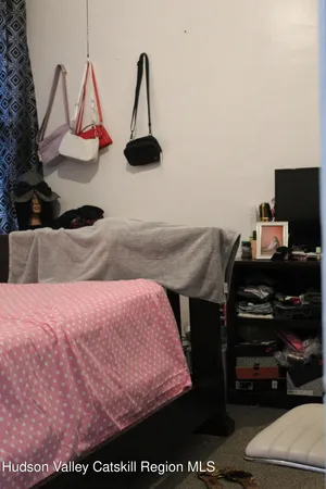 a bedroom with a bed chair and window