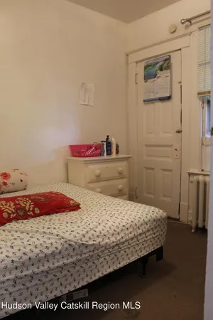 a bedroom with a bed and a dresser in it