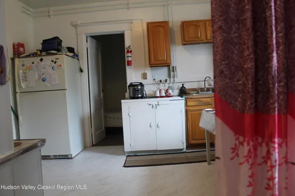 a kitchen with a refrigerator and cabinets