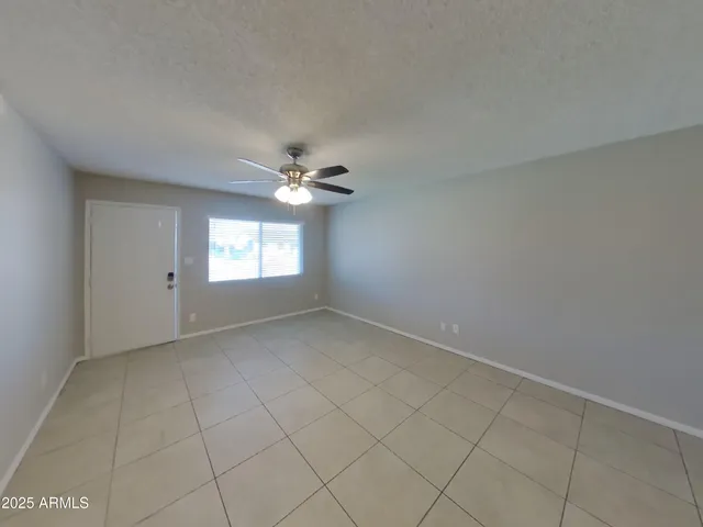 a picture of a rug with a white wall and a painting