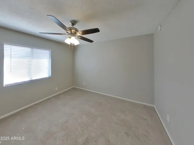 a large kitchen with stainless steel appliances granite countertop a stove top oven a sink and a refrigerator