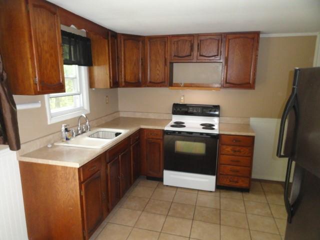 121 North Ridge Road Butler, PA 16001 - Photo 4 of 13 a kitchen with kitchen island granite countertop a sink stove and refrigerator