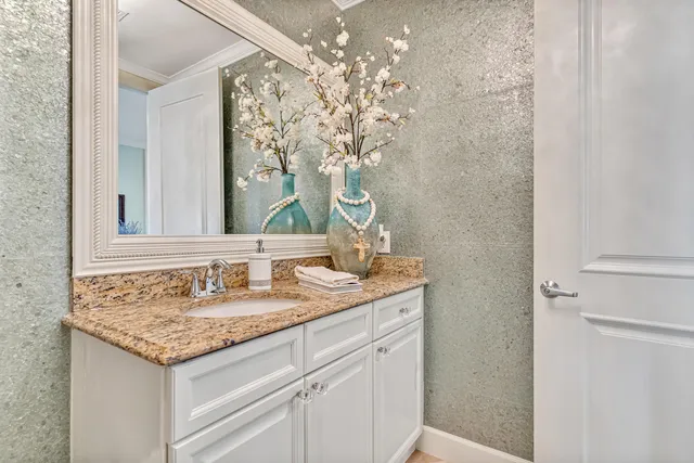 a bedroom with a bed a couch and a flat screen television