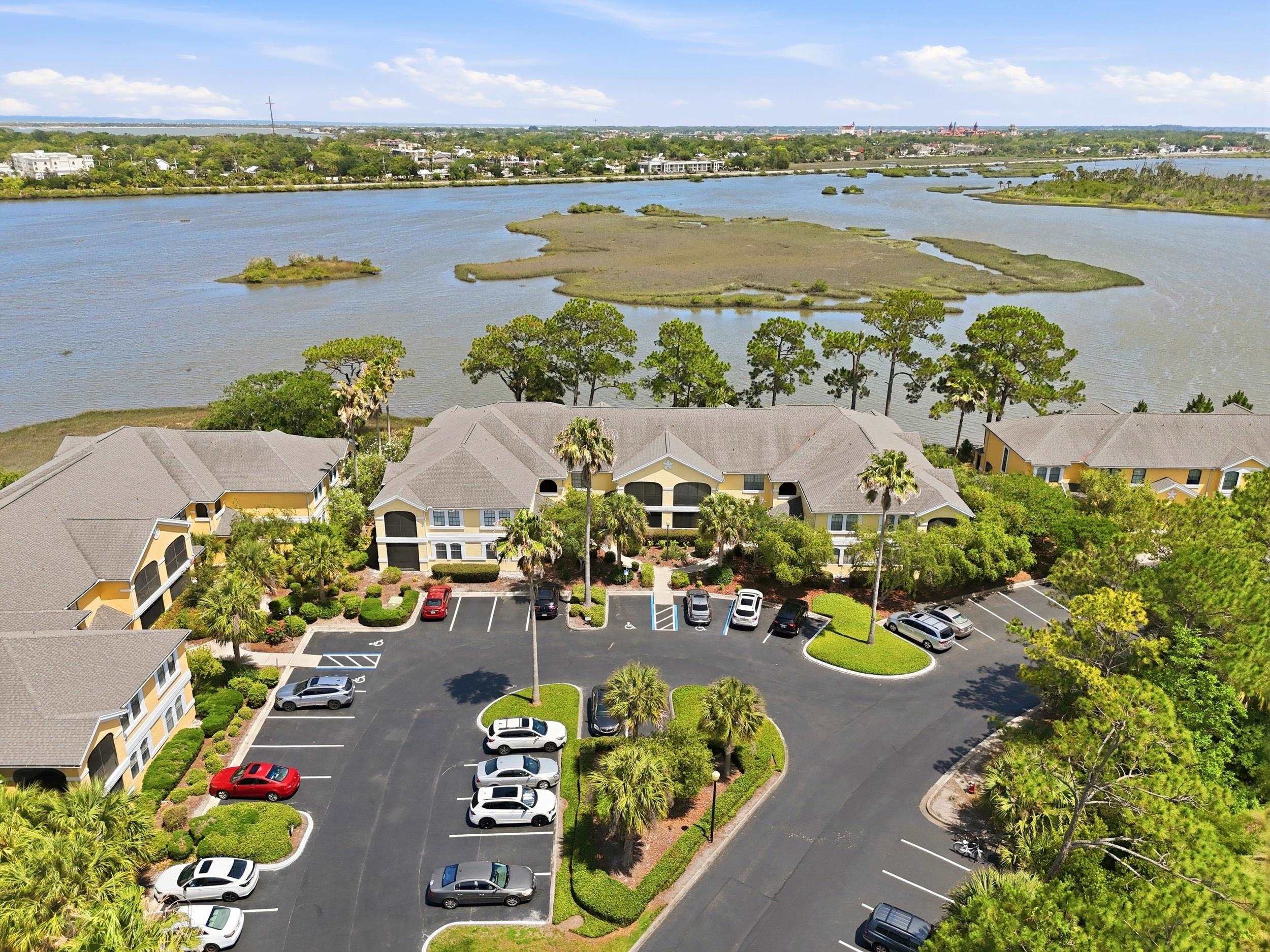 an aerial view of lake and residential houses with outdoor space