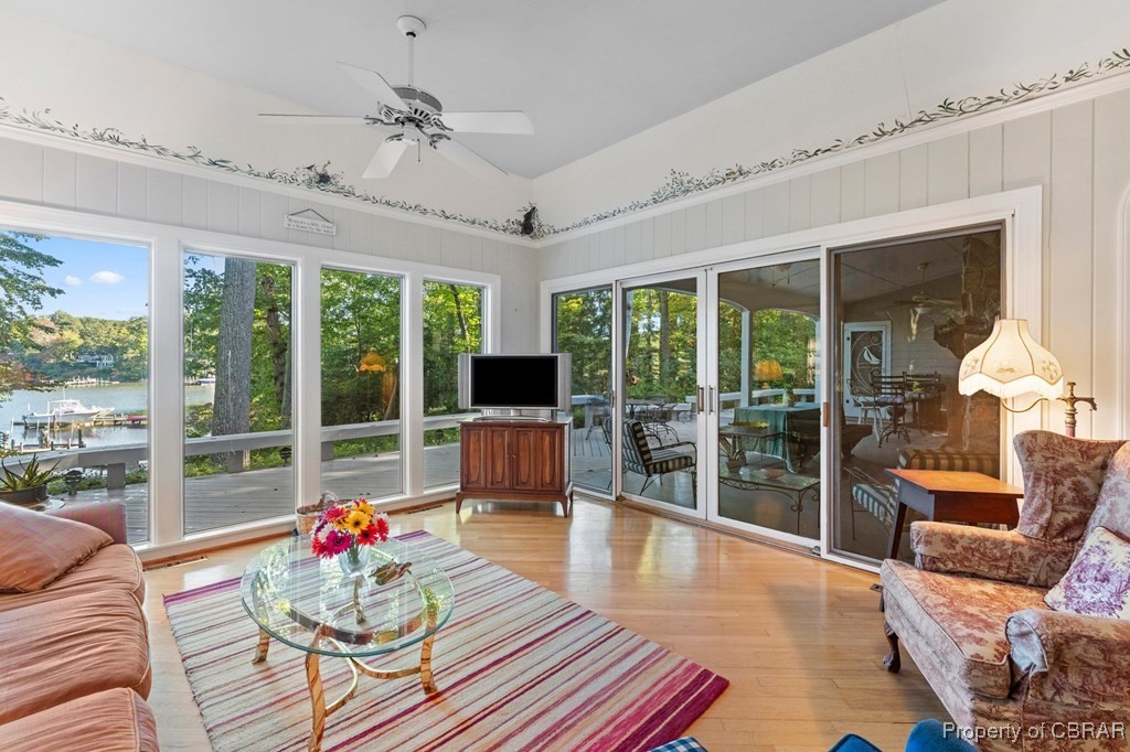 184 York Road Irvington, VA 22480 - Photo 17 of 46 Sunroom with a wealth of natural light, a water view, lofted ceiling, and ceiling fan