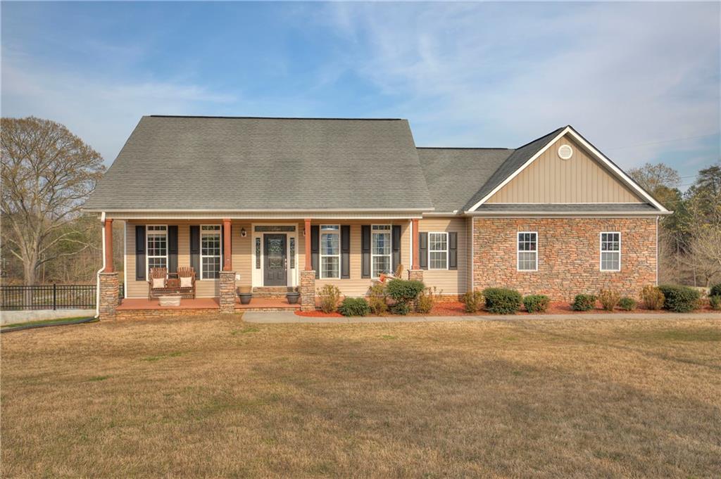 3480 Pine Log Road Northeast Rydal, GA 30171 - Photo 1 of 1 a front view of a house with a yard and seating space