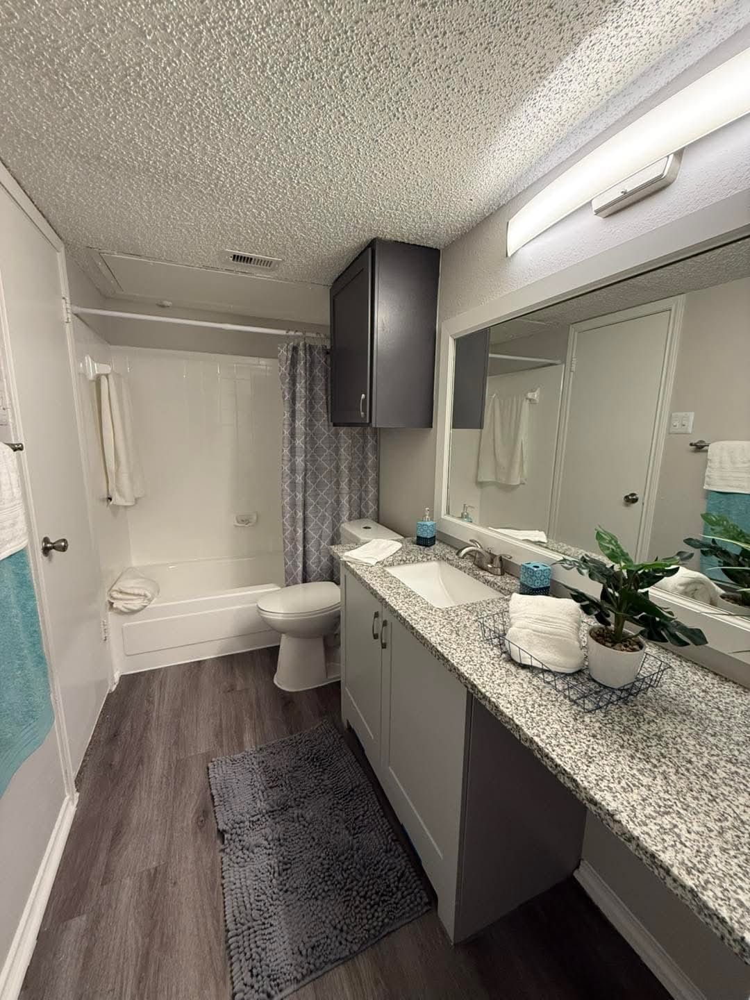 3737 Timberglen Road, Unit 909 Dallas, TX 75287 - Photo 9 of 19 a bathroom with a granite countertop sink a toilet a mirror and vanity