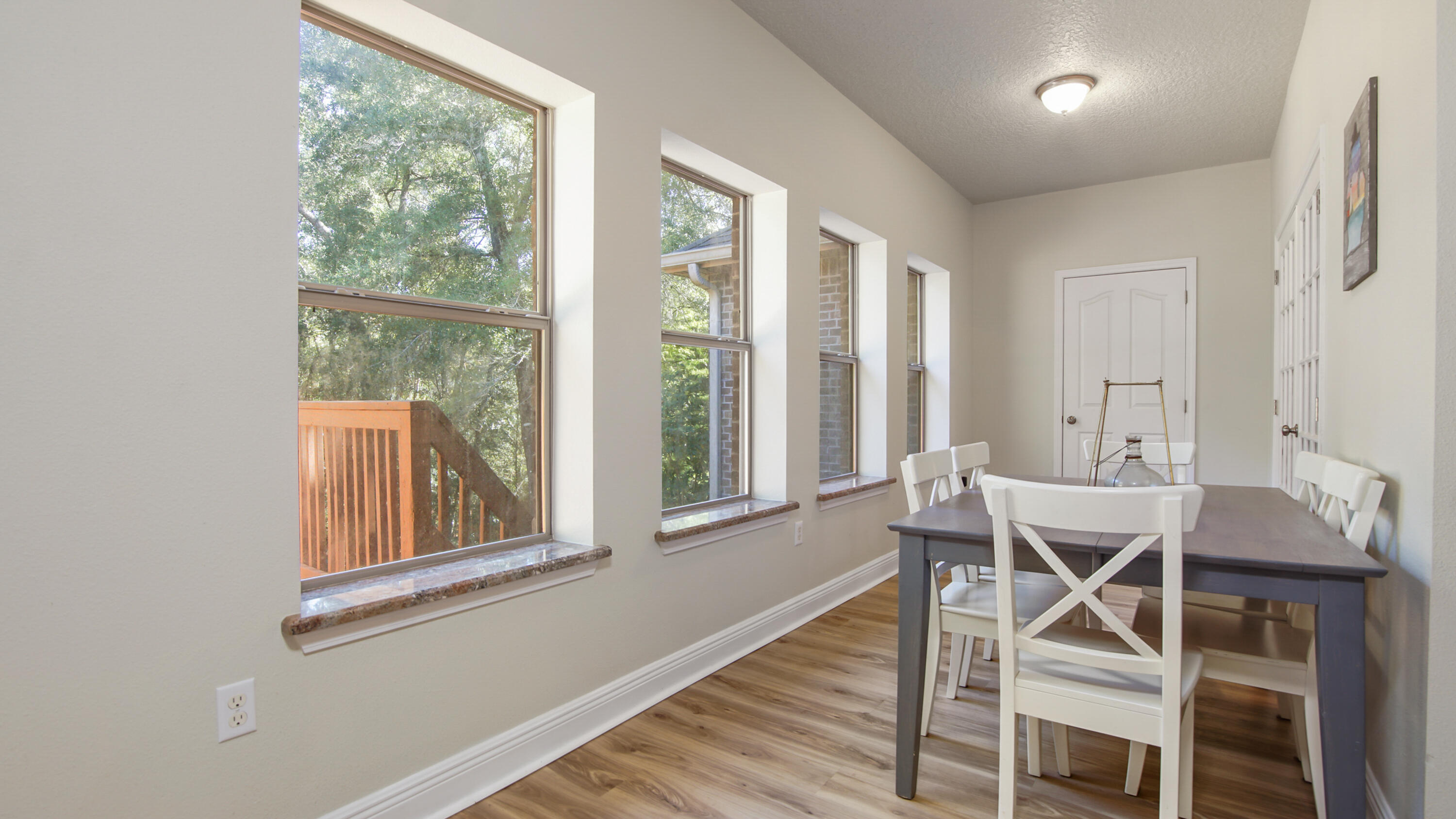 446 Mango Lane Freeport, FL 32439 - Photo 11 of 74 a view of a dining room with furniture and wooden floor