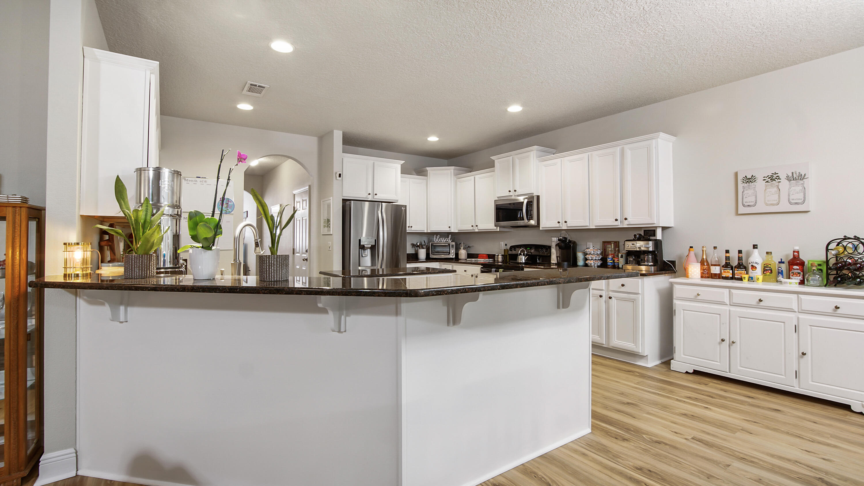 446 Mango Lane Freeport, FL 32439 - Photo 11 of 73 a kitchen with stainless steel appliances granite countertop a stove a sink and a microwave
