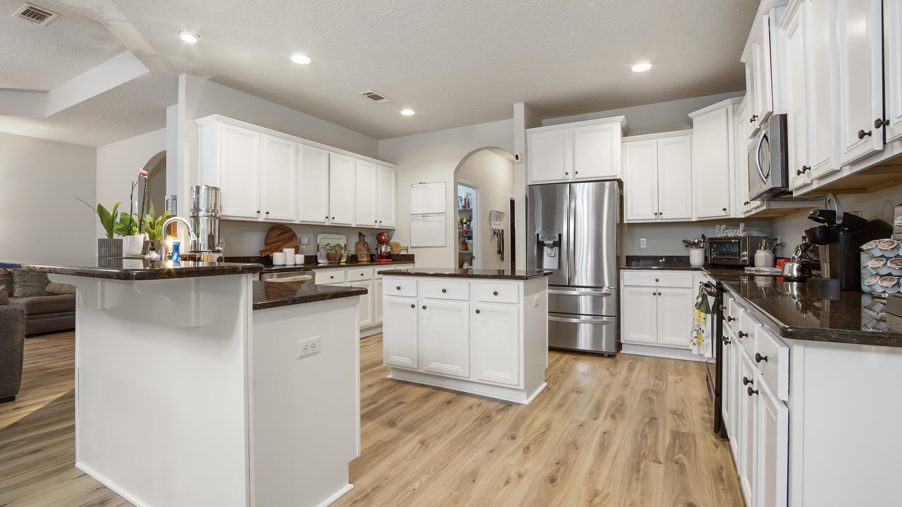 446 Mango Lane Freeport, FL 32439 - Photo 12 of 73 a kitchen with stainless steel appliances a refrigerator sink and cabinets
