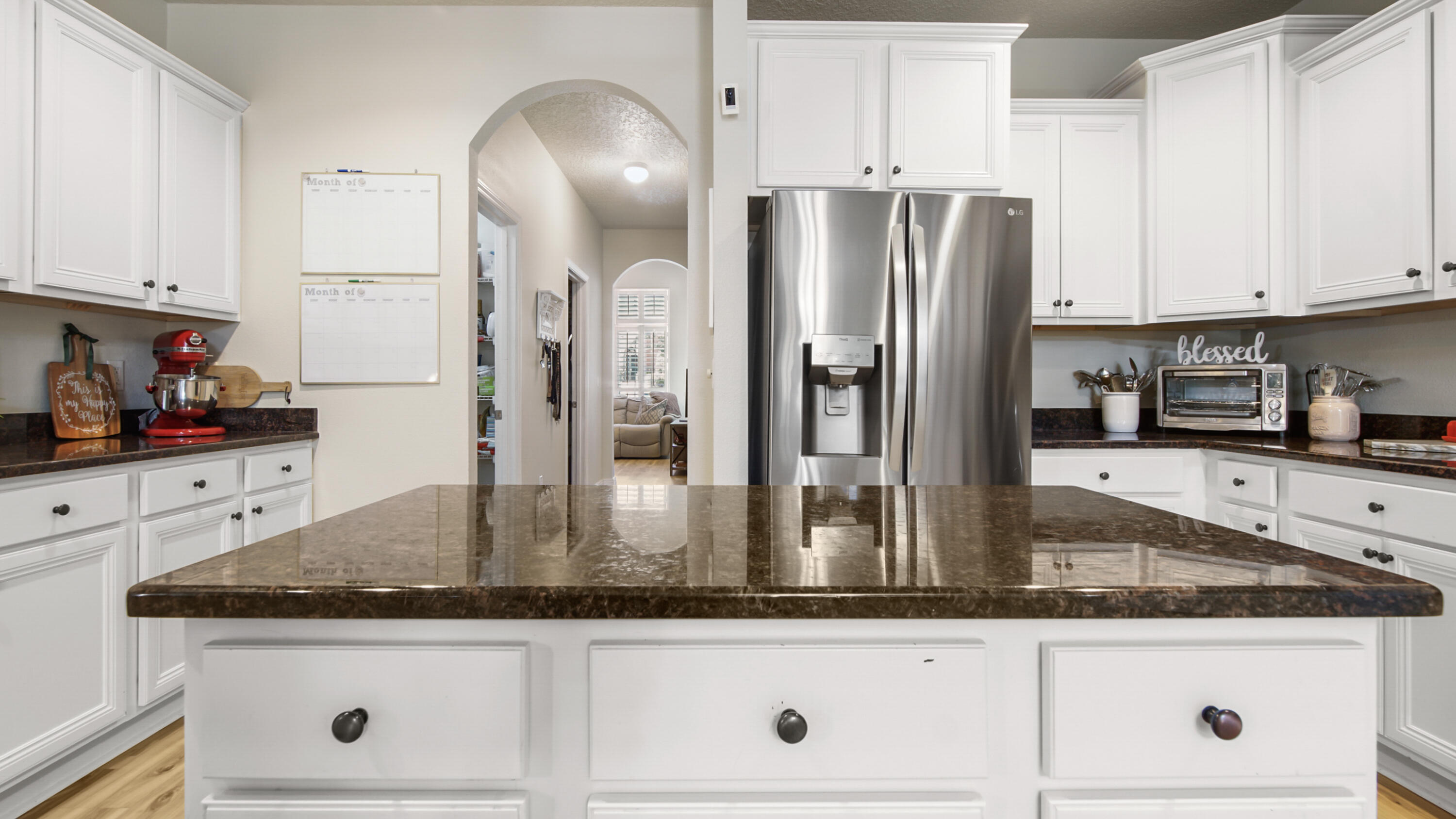 446 Mango Lane Freeport, FL 32439 - Photo 13 of 73 a kitchen with granite countertop stainless steel appliances a refrigerator a stove and white cabinets