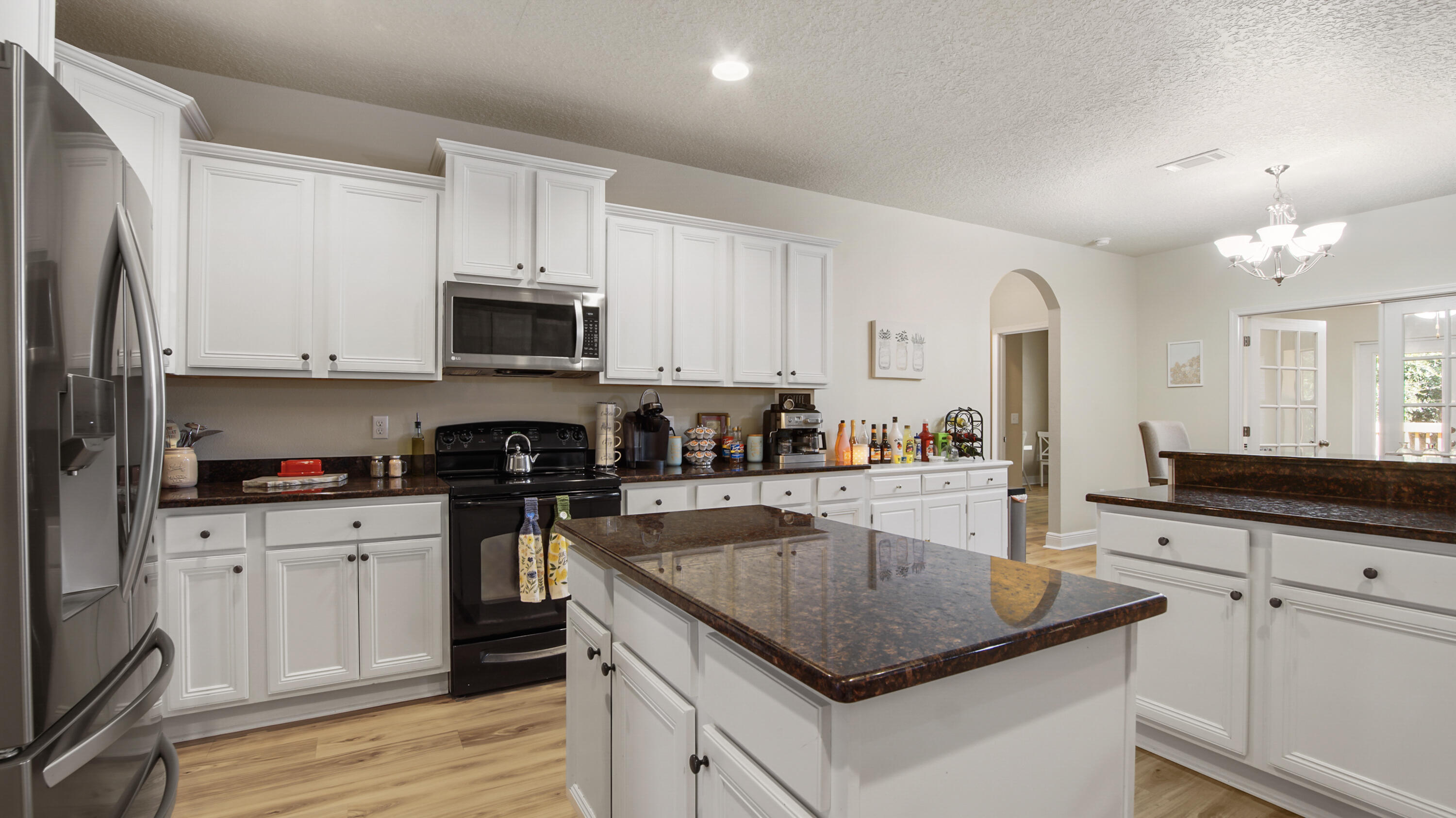 446 Mango Lane Freeport, FL 32439 - Photo 14 of 73 a kitchen with granite countertop a sink a stove and cabinets