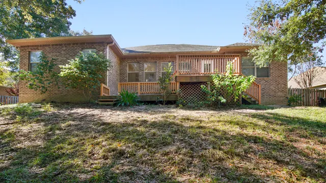 an aerial view of a house with a yard and lake view