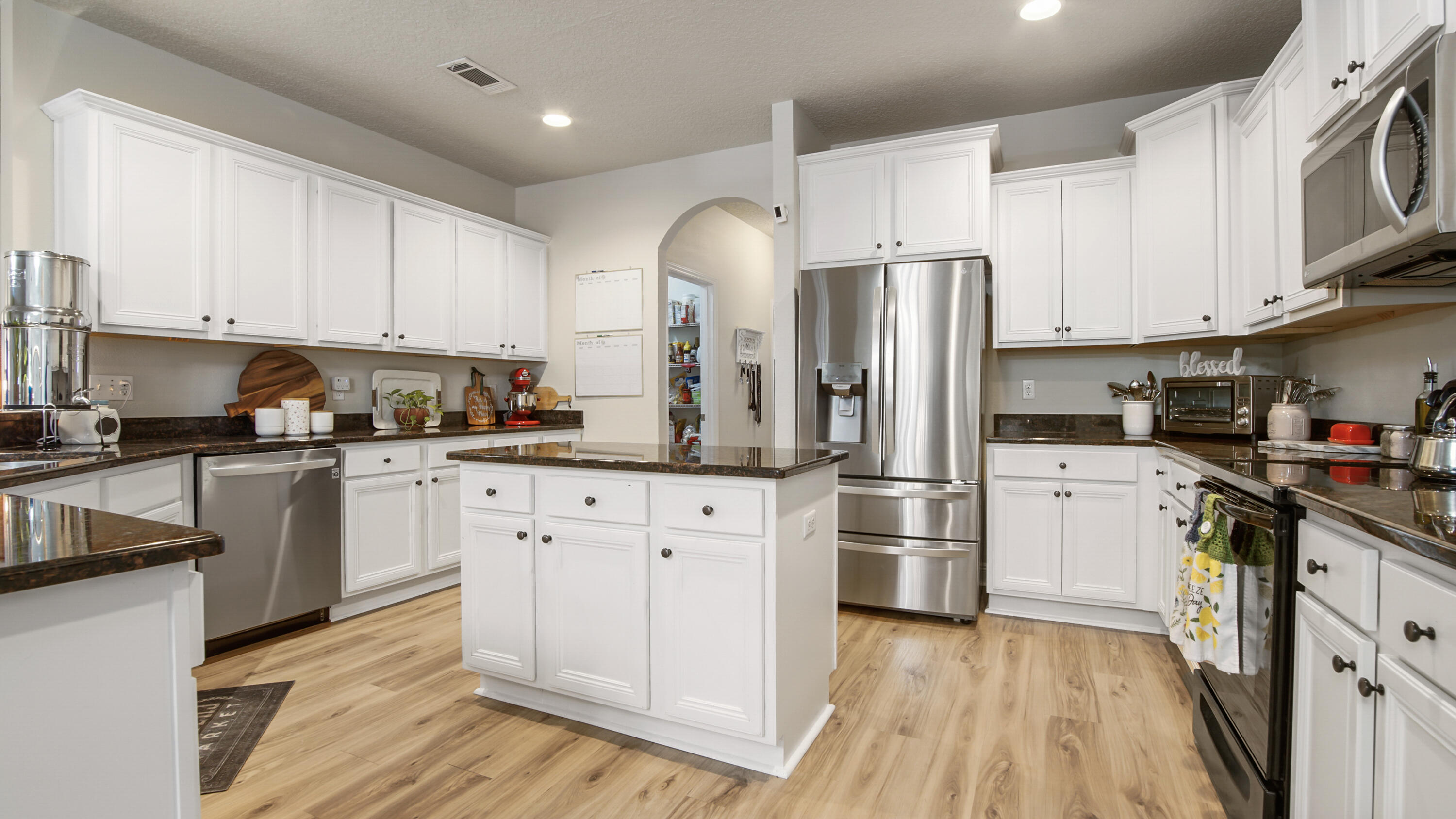 446 Mango Lane Freeport, FL 32439 - Photo 3 of 73 a kitchen with stainless steel appliances granite countertop a refrigerator sink and cabinets