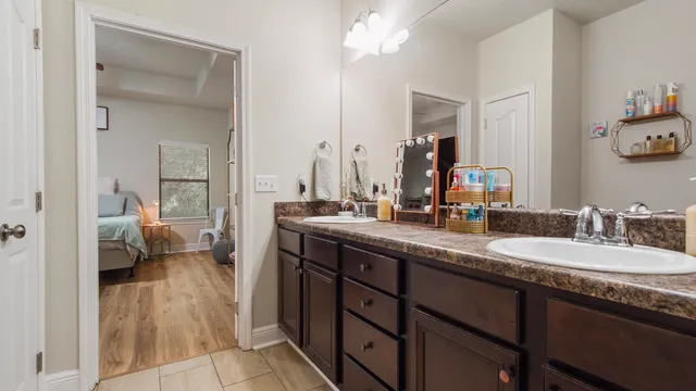 a bathroom with a granite countertop sink and a mirror