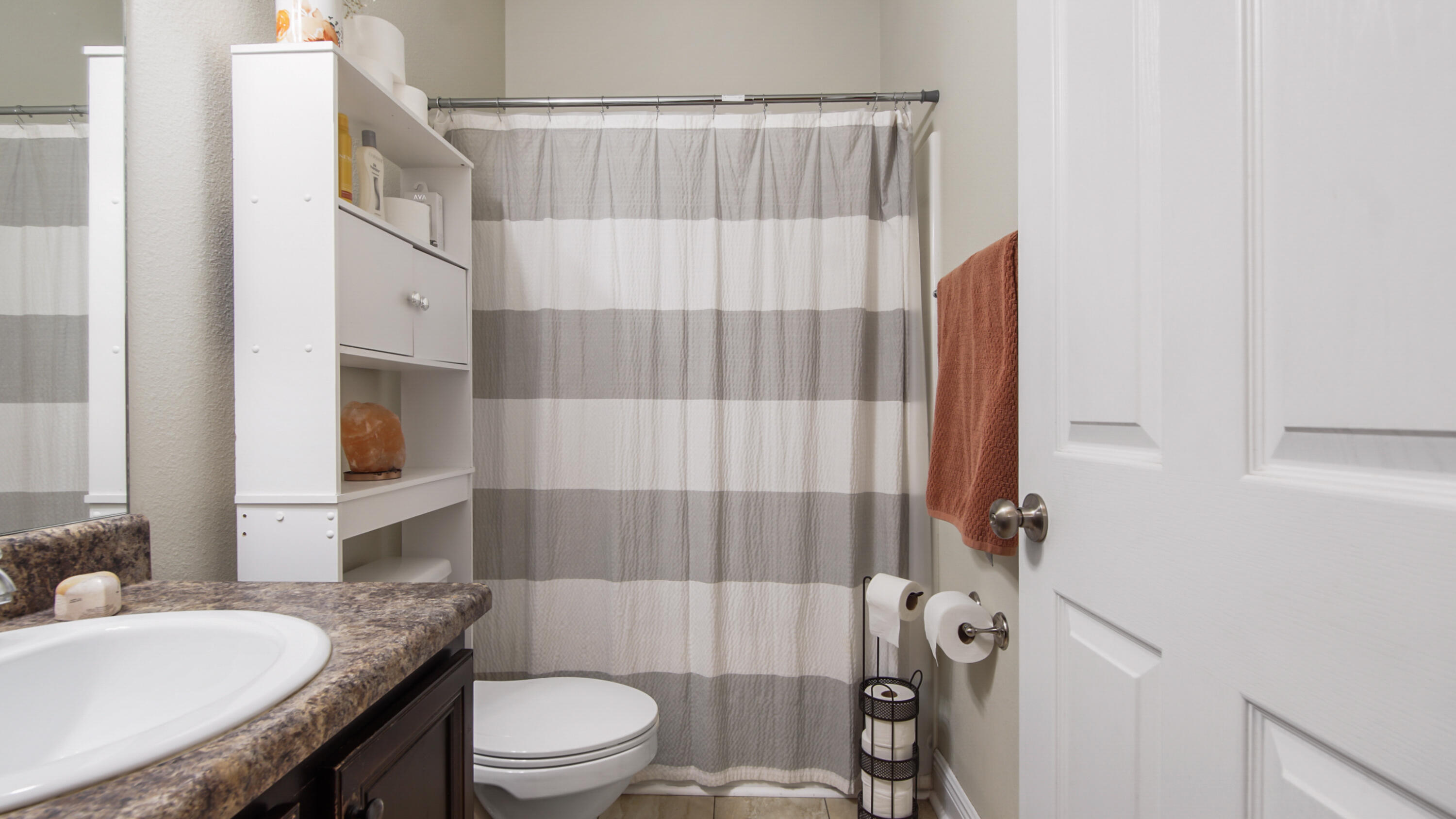 446 Mango Lane Freeport, FL 32439 - Photo 48 of 73 a bathroom with a granite countertop sink toilet a mirror and shower
