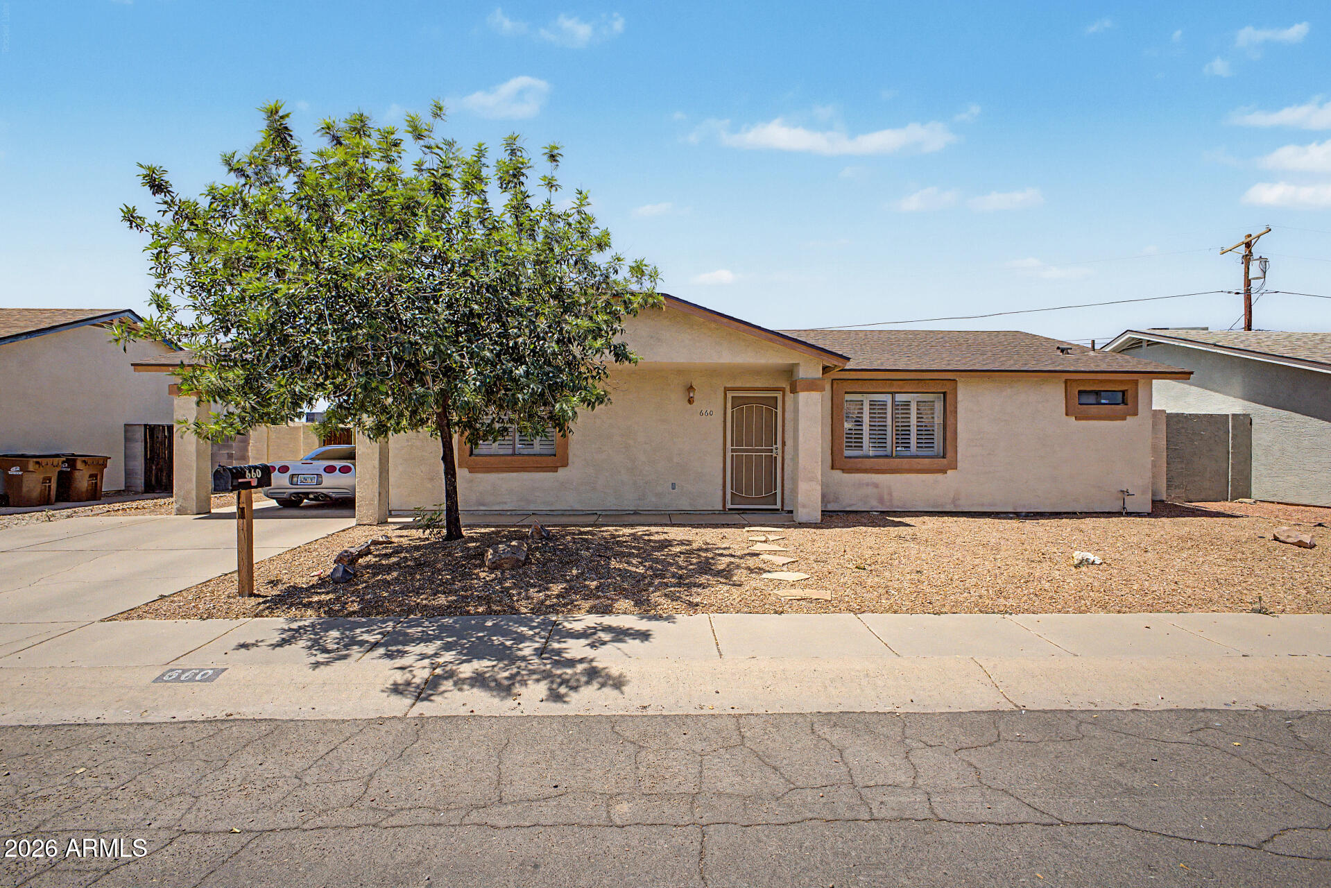 660 South Stardust Lane Apache Junction, AZ 85120 - Photo 1 of 15 a front view of a house with a yard and garage