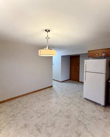 a view of a kitchen with a refrigerator and a refrigerator