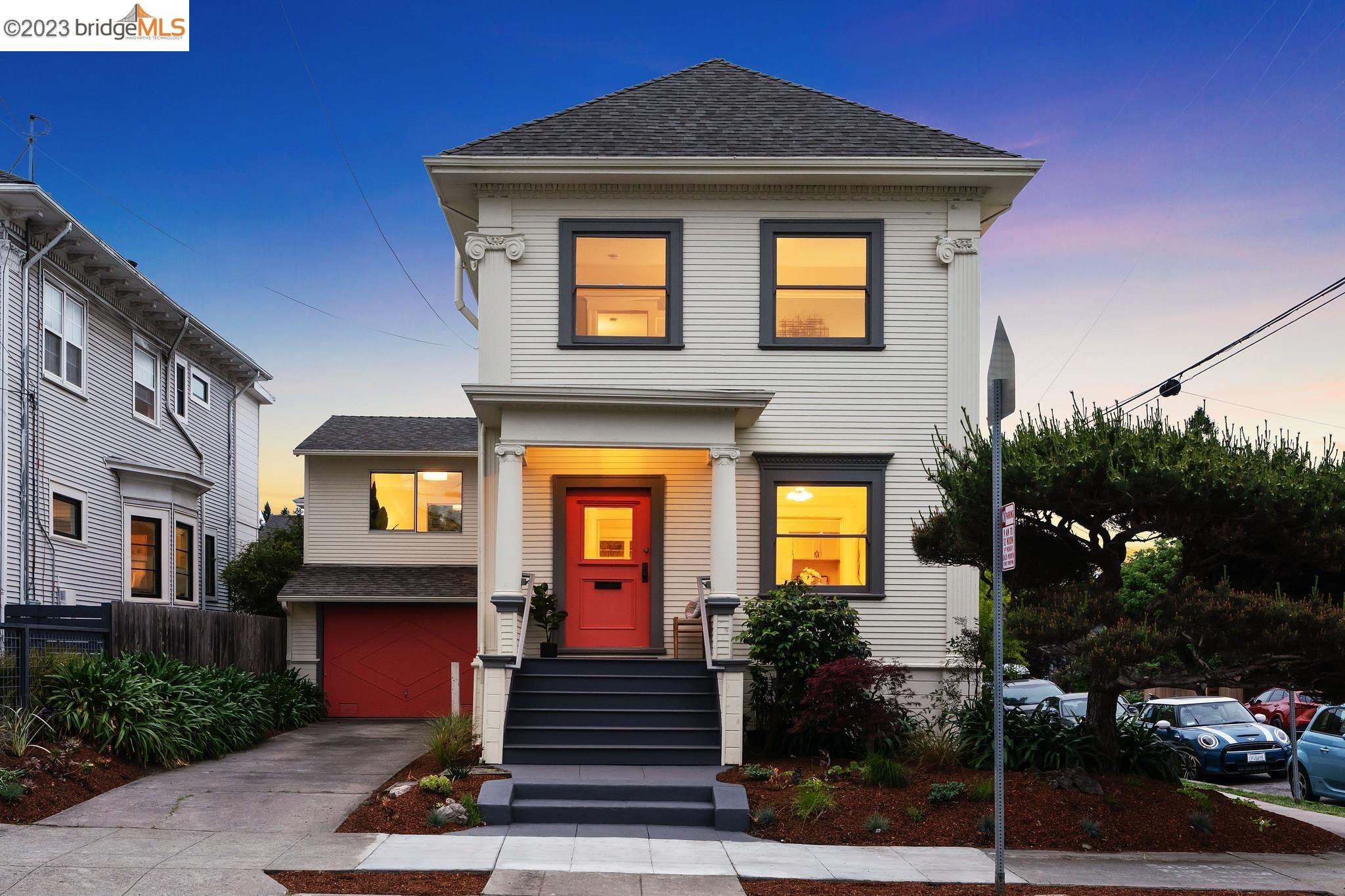 a front view of a house with plants