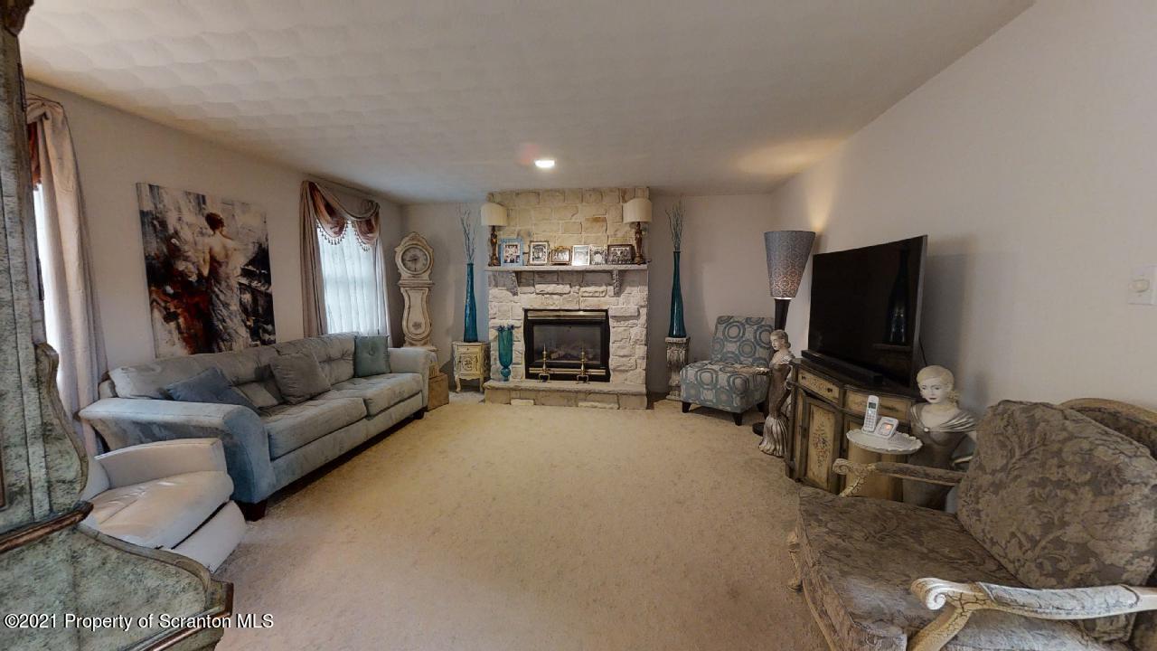 1355 Oak Drive Shavertown, PA 18708 - Photo 10 of 32 a living room with furniture a flat screen tv and a fireplace