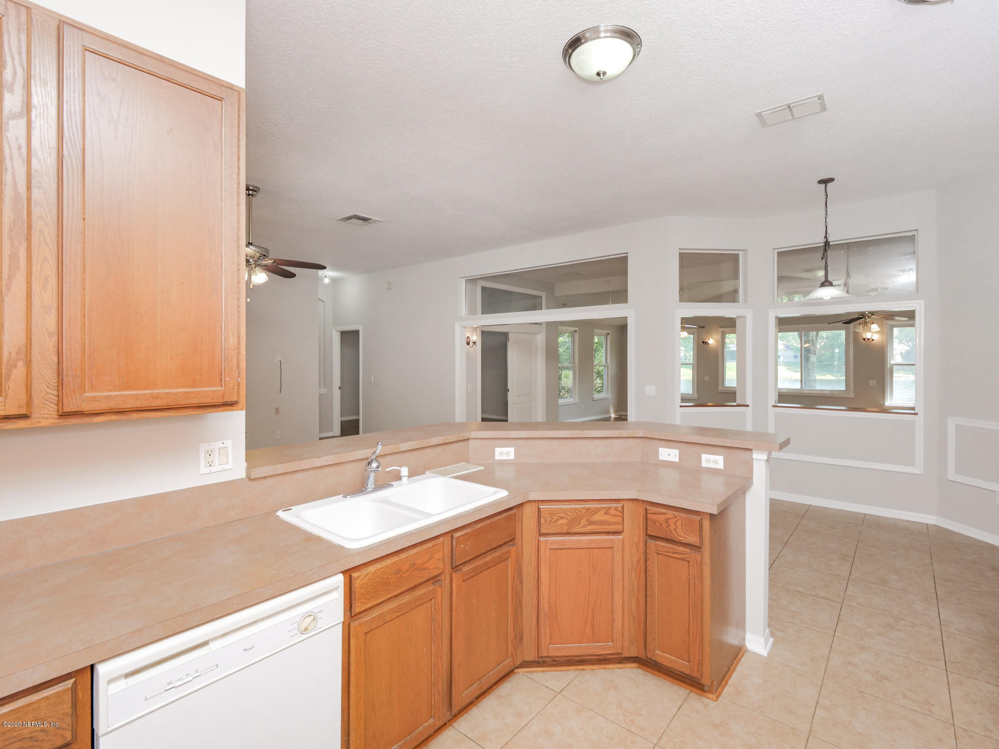 8663 Reedy Branch Drive Jacksonville, FL 32256 - Photo 13 of 33 a spacious bathroom with a granite countertop sink and a mirror