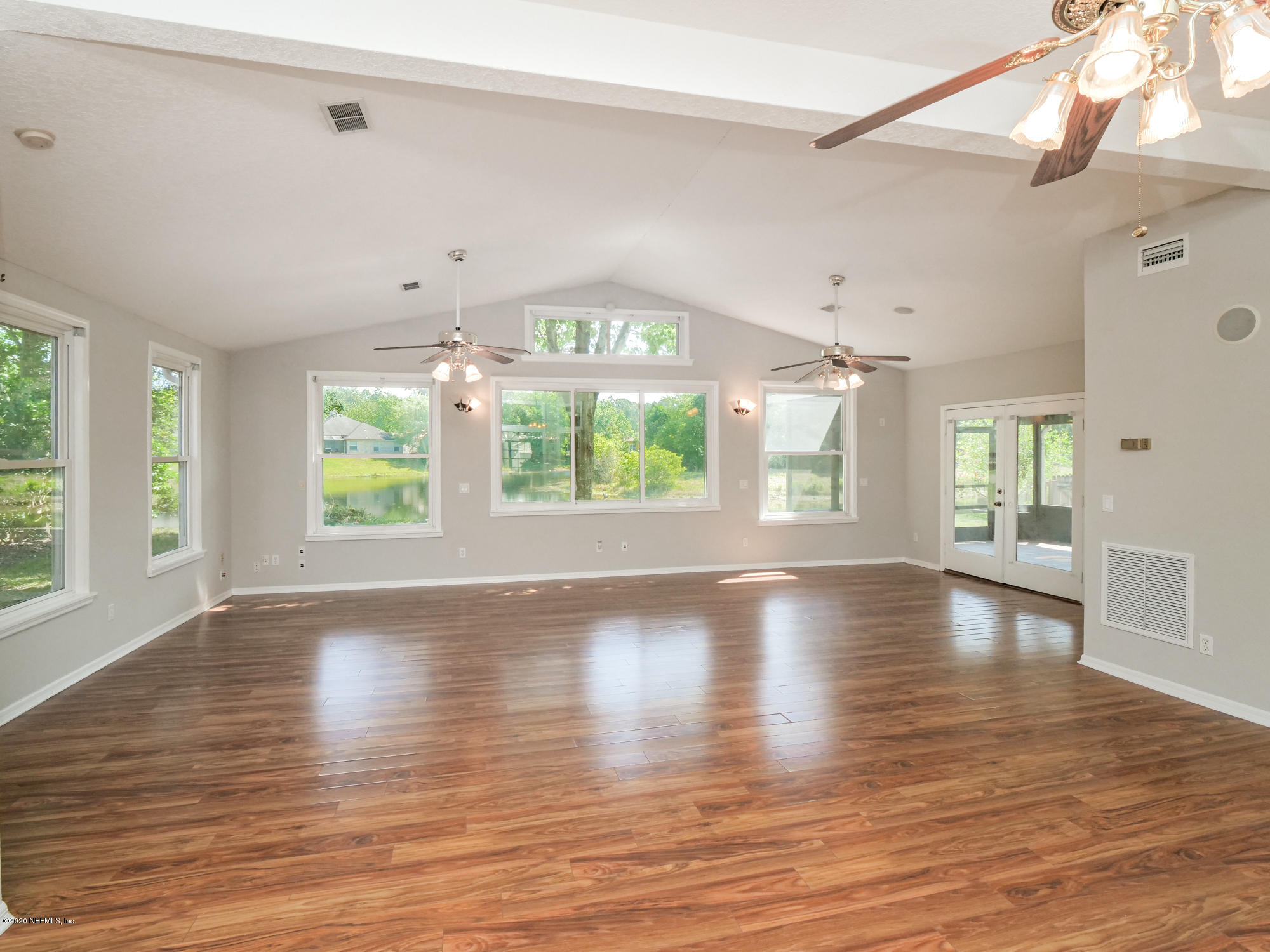 8663 Reedy Branch Drive Jacksonville, FL 32256 - Photo 14 of 33 a view of an empty room with wooden floor and a window