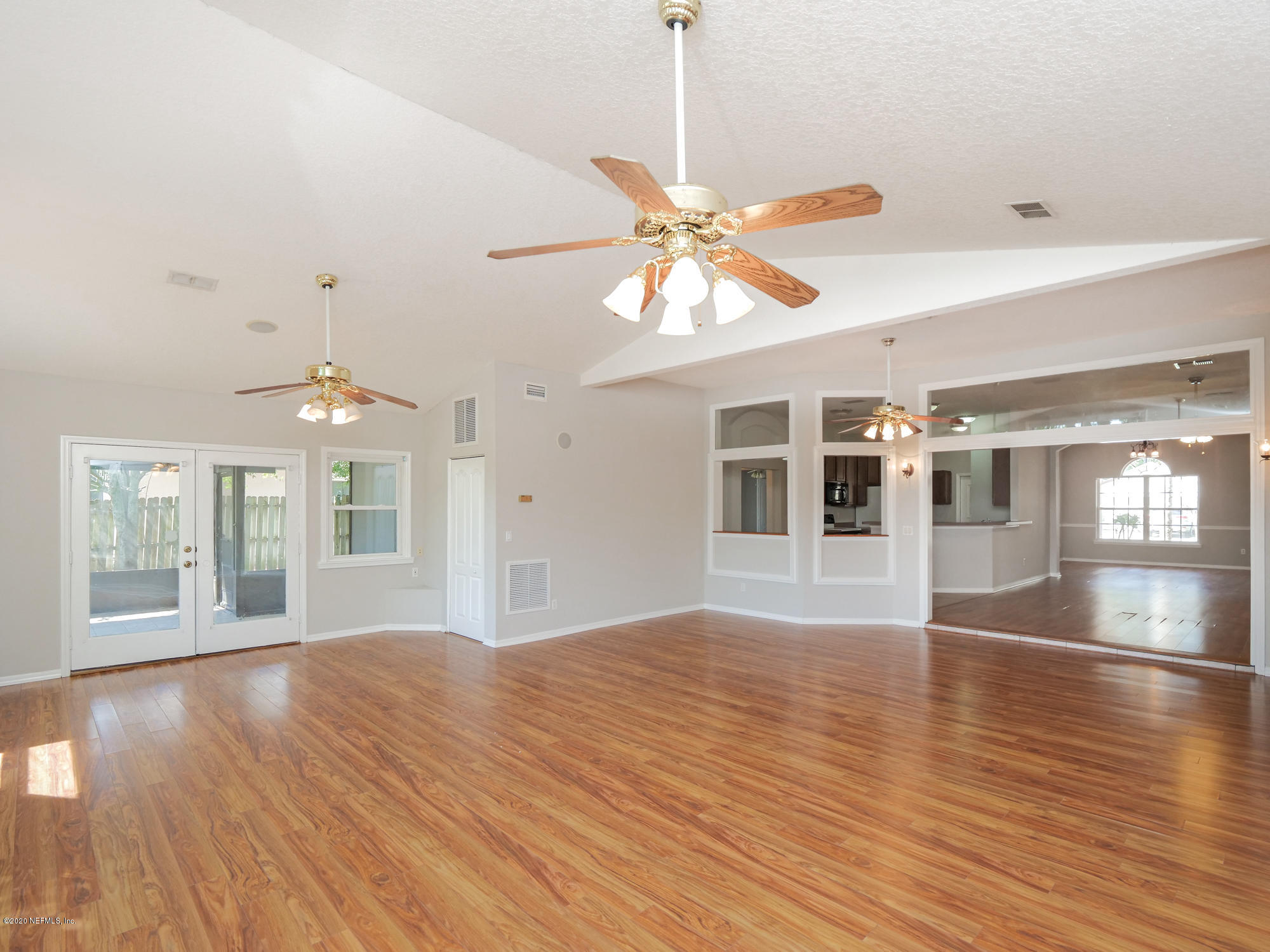 8663 Reedy Branch Drive Jacksonville, FL 32256 - Photo 16 of 33 a view of an empty room with window and wooden floor