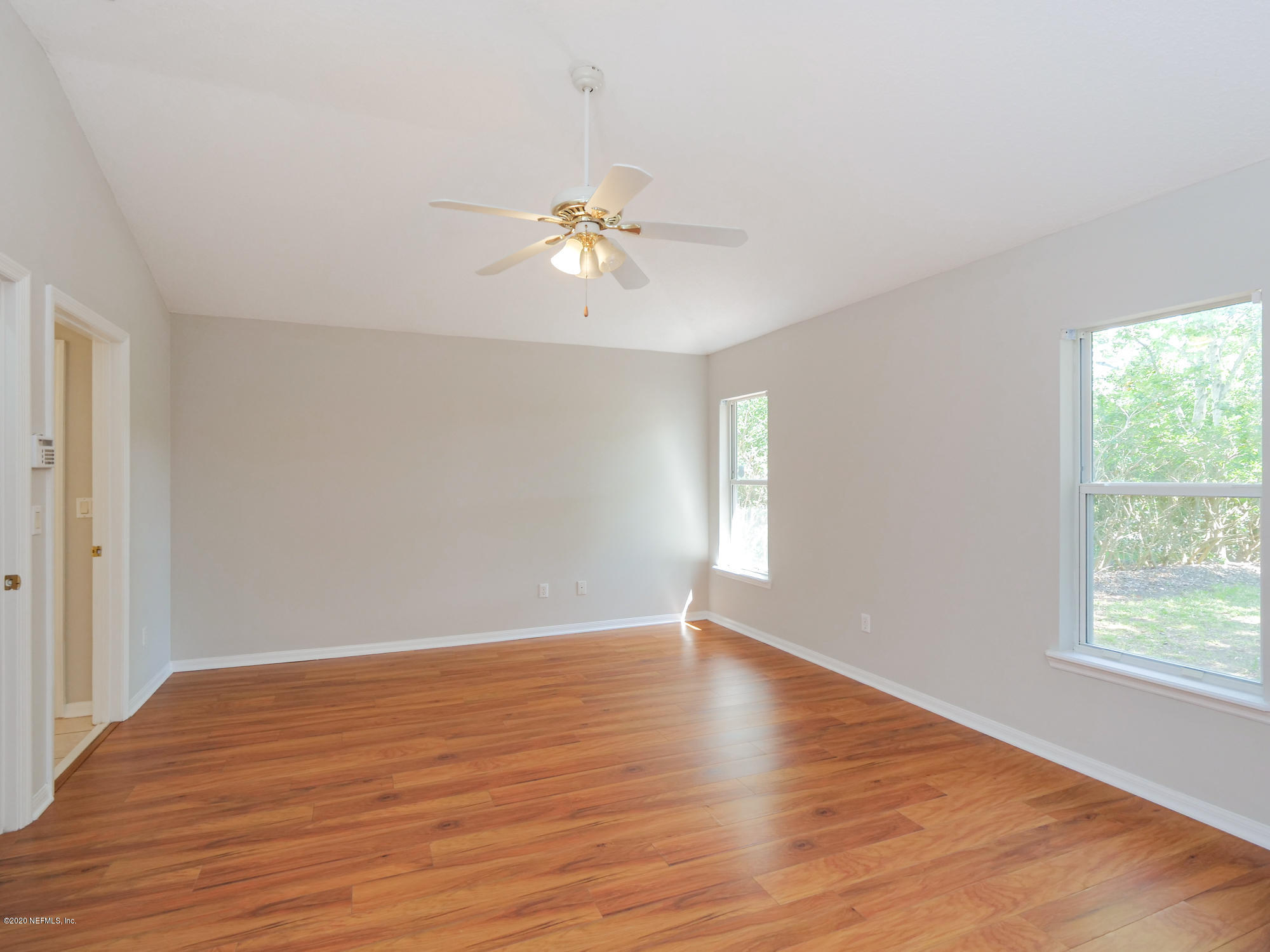 8663 Reedy Branch Drive Jacksonville, FL 32256 - Photo 17 of 33 a view of an empty room with a window and wooden floor