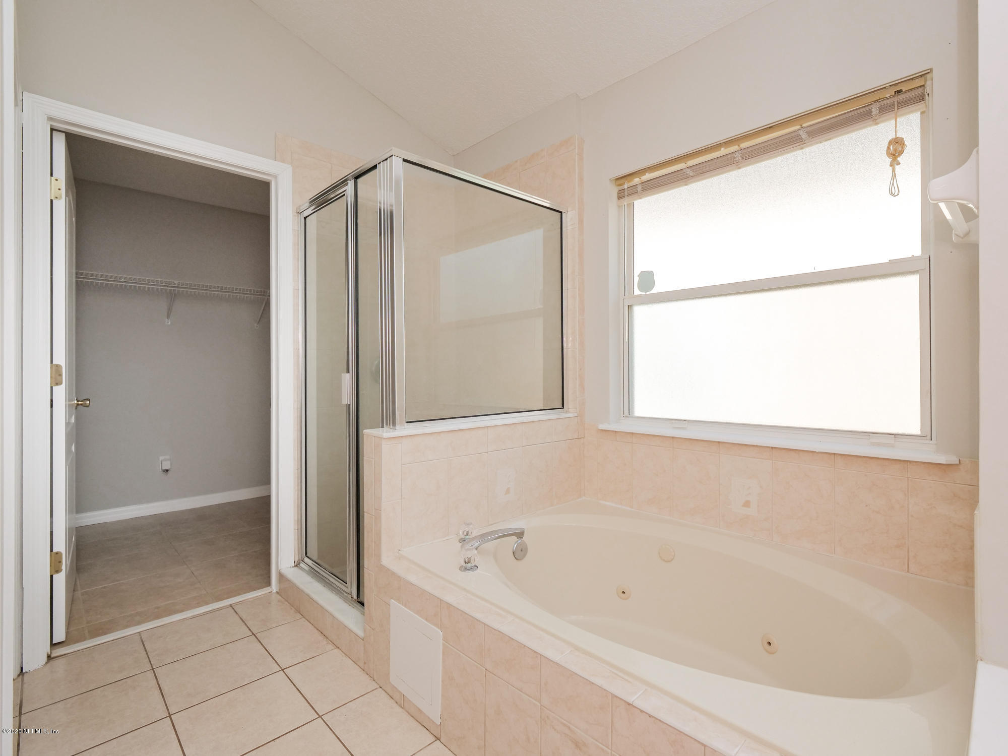 8663 Reedy Branch Drive Jacksonville, FL 32256 - Photo 20 of 33 a bathroom with a bathtub and a shower