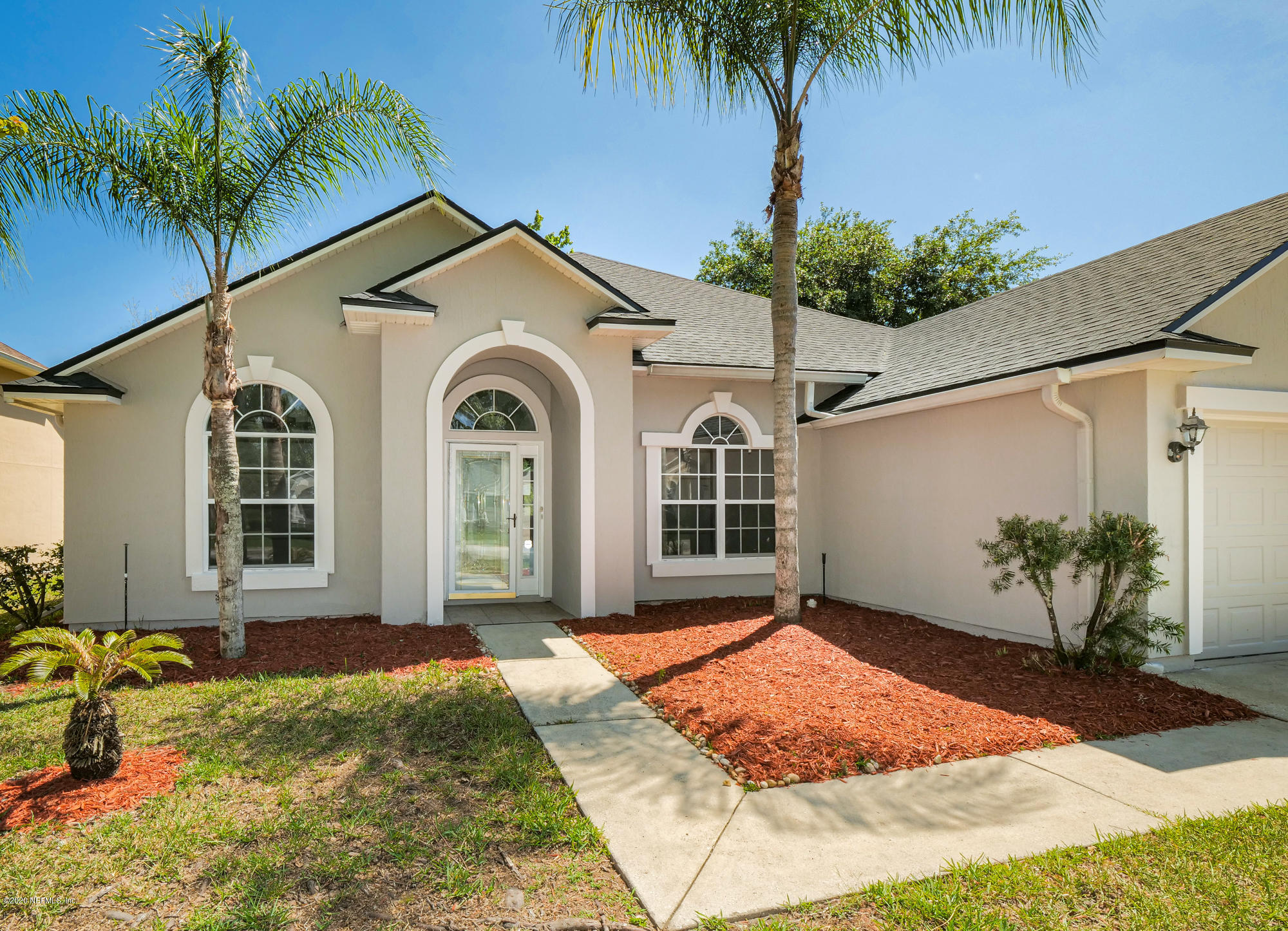 8663 Reedy Branch Drive Jacksonville, FL 32256 - Photo 2 of 33 a front view of a house with garden