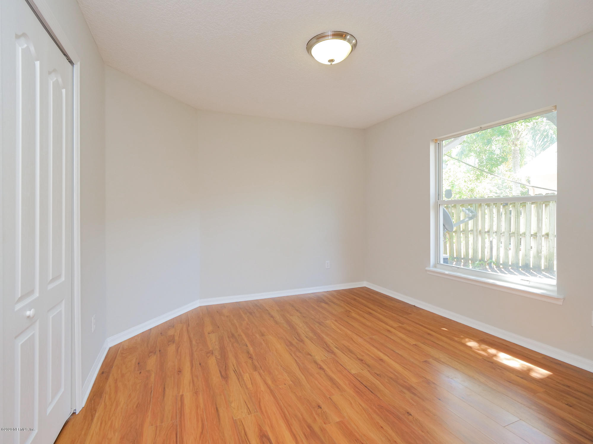 8663 Reedy Branch Drive Jacksonville, FL 32256 - Photo 22 of 33 wooden floor in an empty room with a window