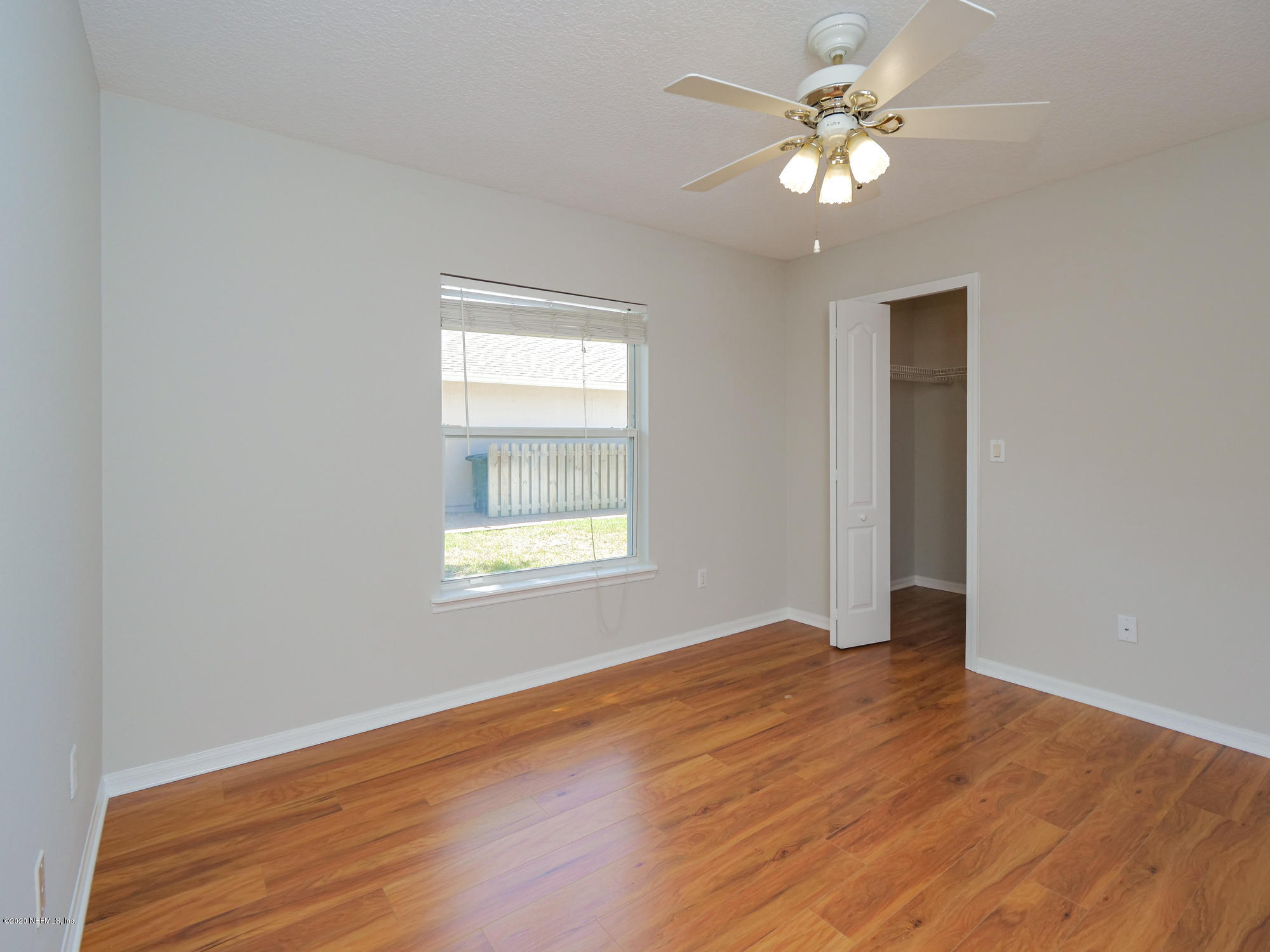 8663 Reedy Branch Drive Jacksonville, FL 32256 - Photo 25 of 33 wooden floor in an empty room with a window