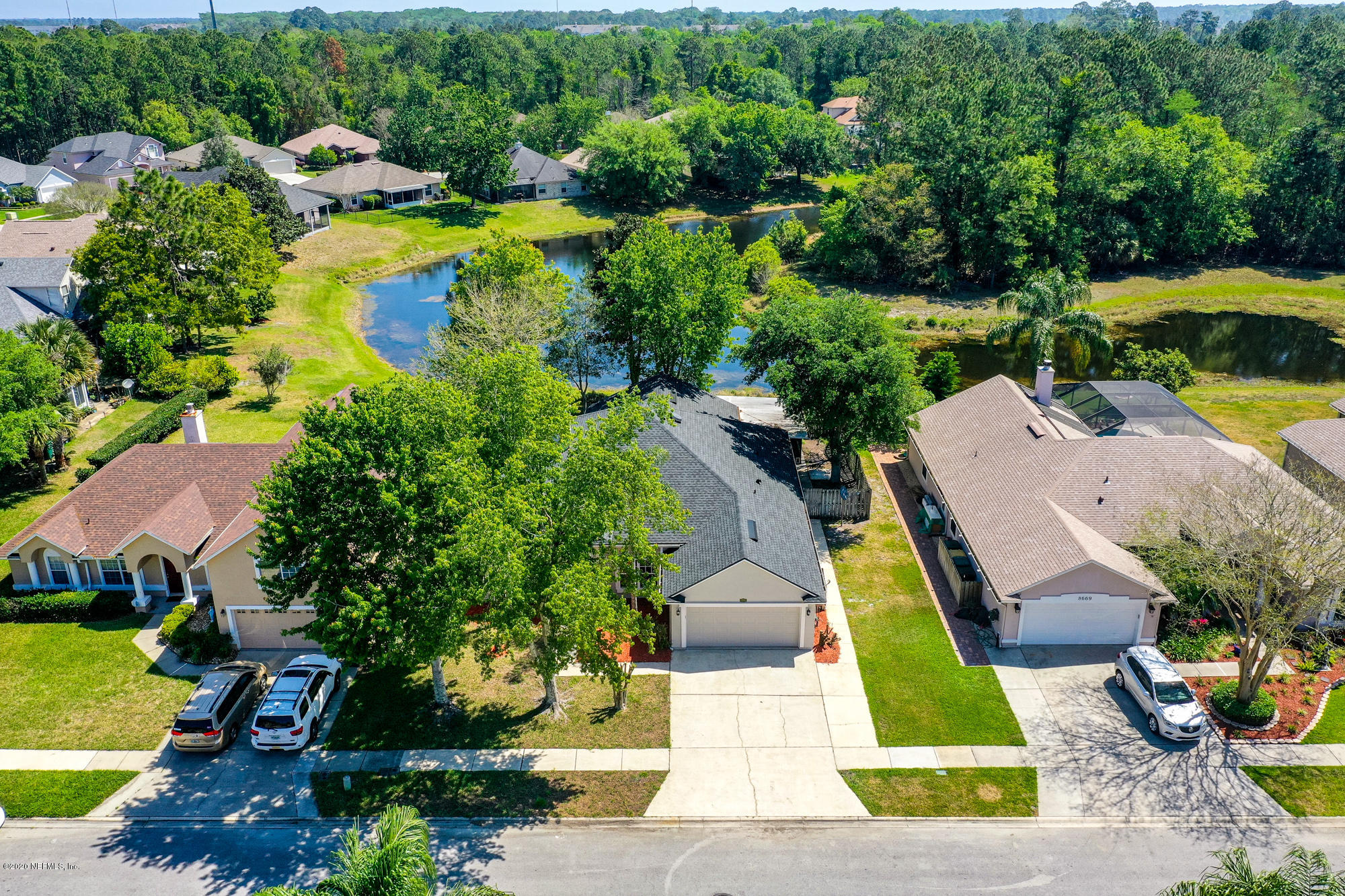 8663 Reedy Branch Drive Jacksonville, FL 32256 - Photo 3 of 33 an aerial view of a house with swimming pool outdoor seating and yard