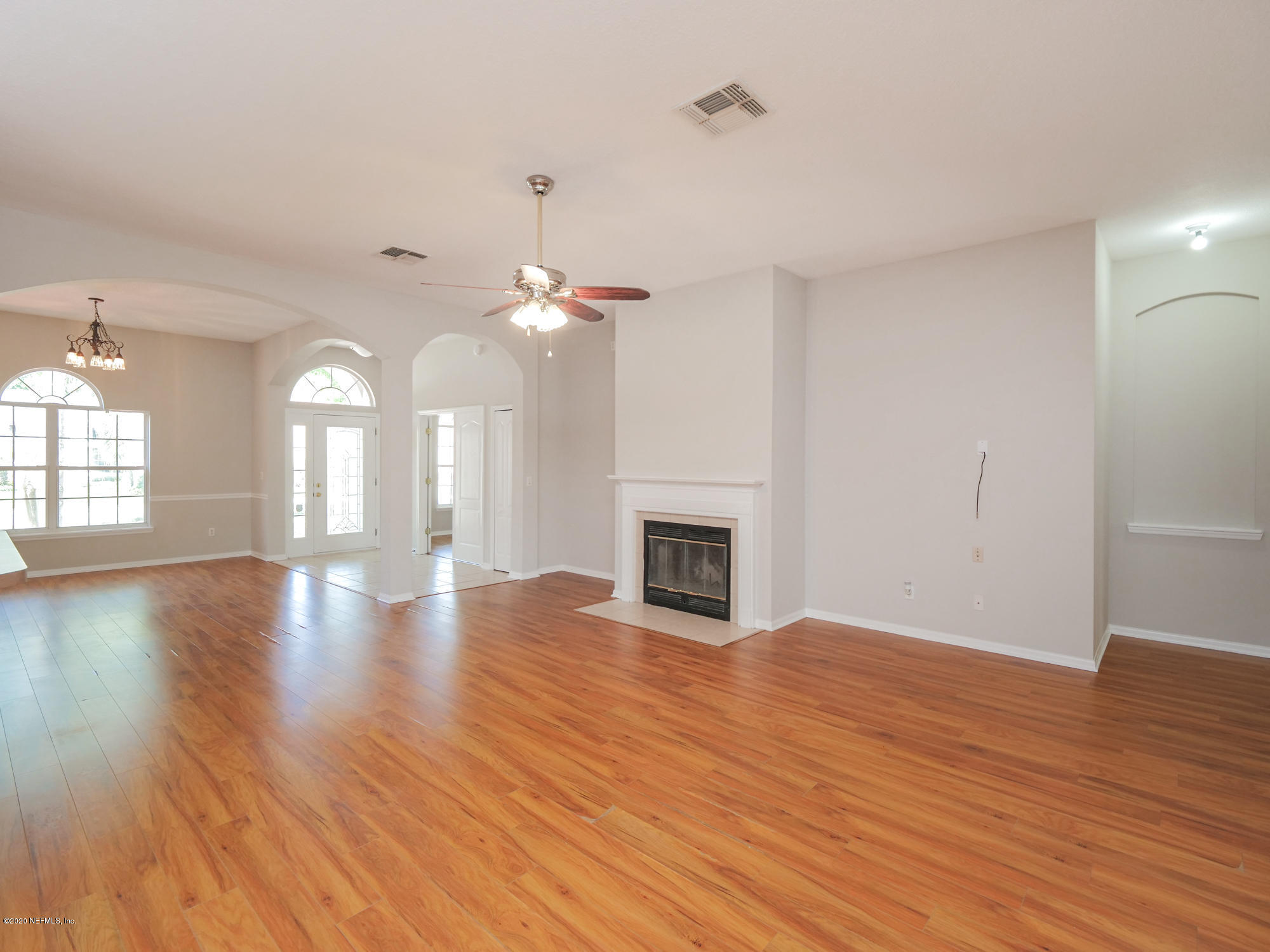 8663 Reedy Branch Drive Jacksonville, FL 32256 - Photo 8 of 33 a view of an empty room with wooden floor and a fireplace