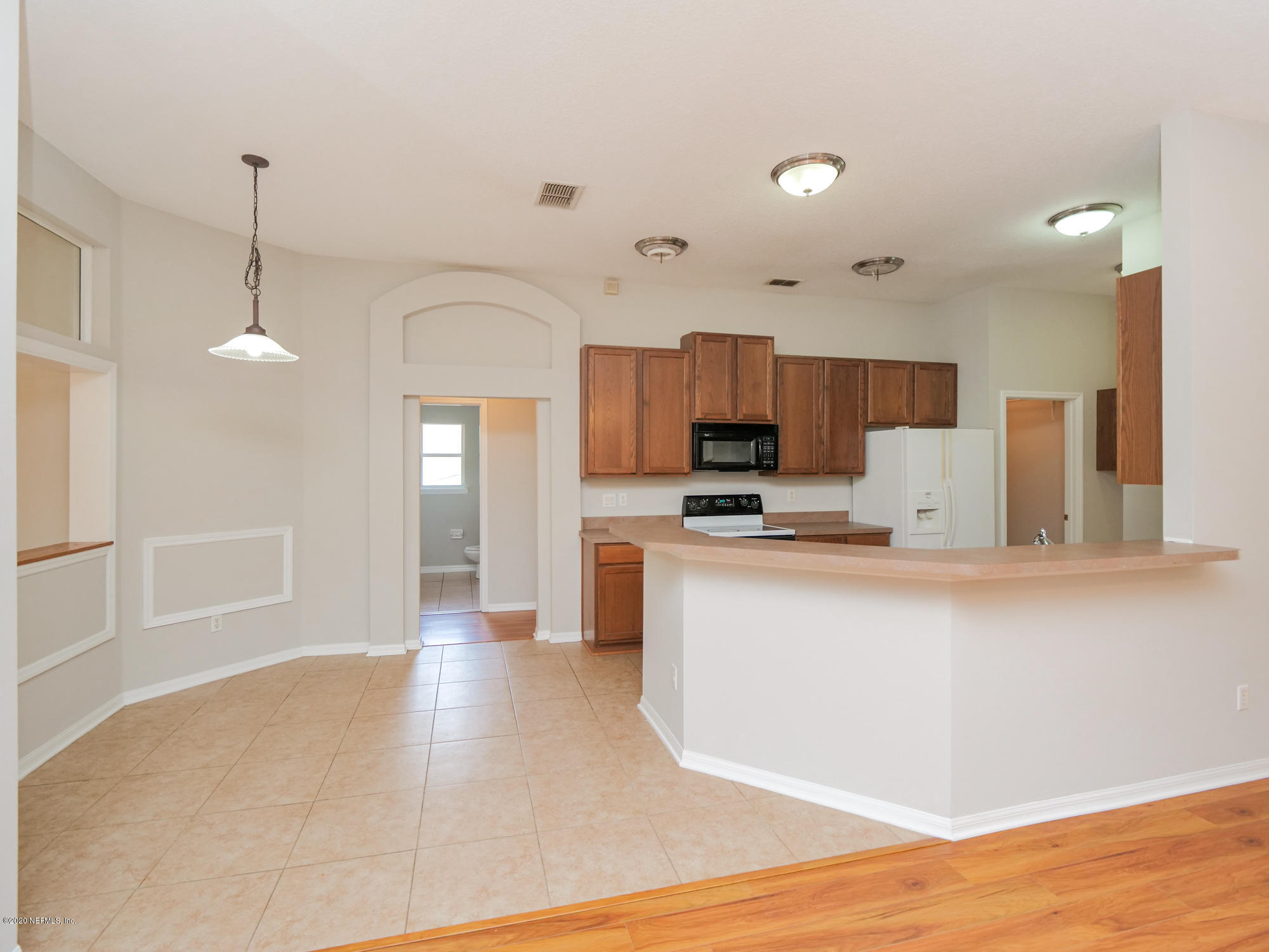 8663 Reedy Branch Drive Jacksonville, FL 32256 - Photo 9 of 33 a large kitchen with cabinets