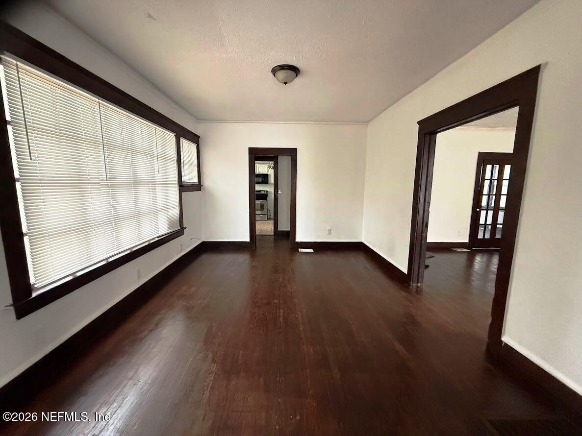 2036 Moncrief Road Jacksonville, FL 32209 - Photo 4 of 32 an empty room with wooden floor and windows