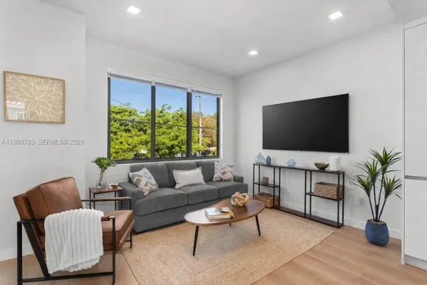 a living room with furniture and a flat screen tv