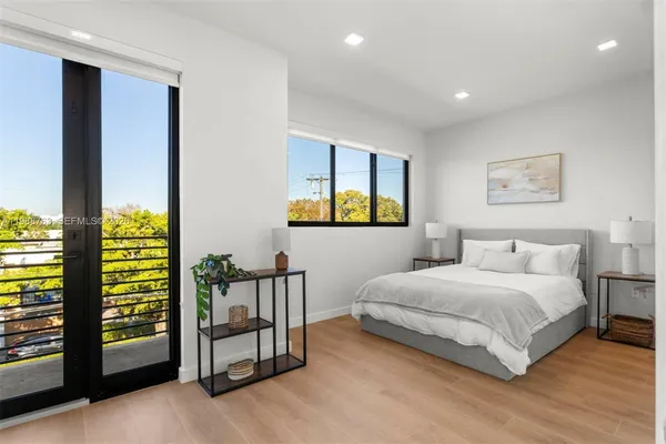 a bedroom with a bed and a night stand