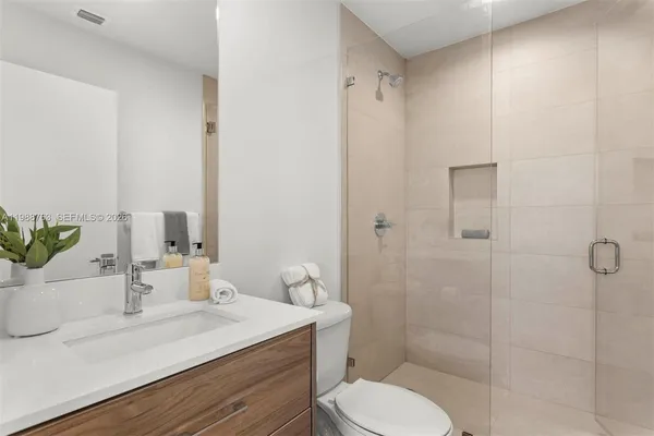 a bathroom with a sink toilet and shower