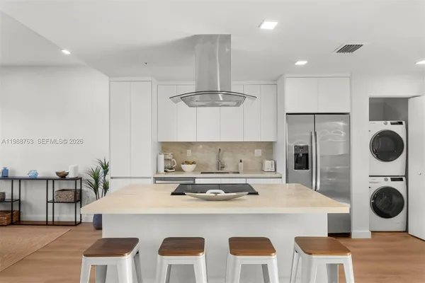 a kitchen with a dining table and chairs