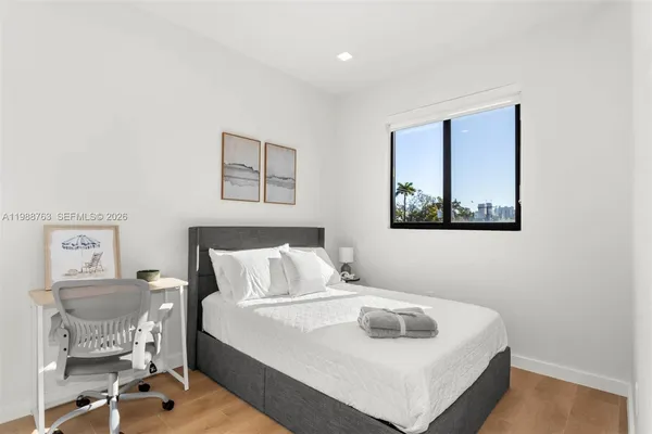 a bedroom with a bed and a table in it