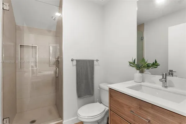 a bathroom with a sink toilet and shower